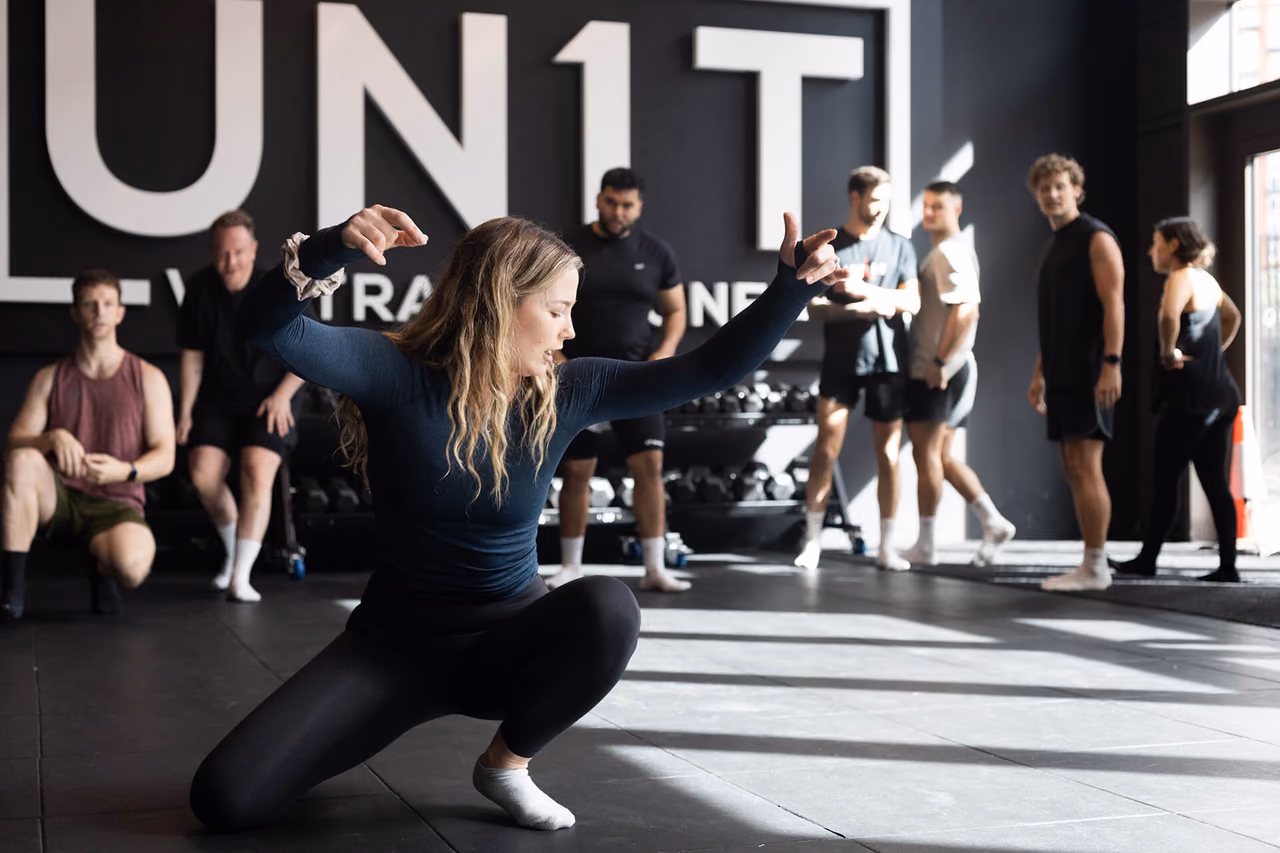 Movement instructor leading a floor session at UN1T Nine Elms
